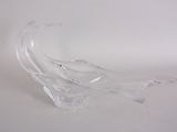 a glass sculpture of a wave on a white surface