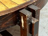 a close up of a wooden table with a piece of wood sticking out of it