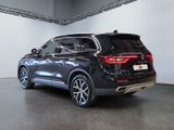 the rear end of a black bmw suv parked in a garage