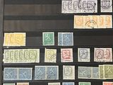 an old picture of a collection of stamps on display in a glass case