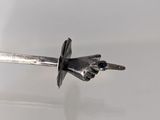 a close up of a knife on a white surface with a black handle