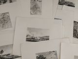 several black and white pictures of a bunch of buildings on a table