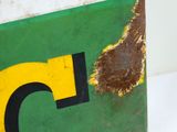 a green and yellow sign with the letter c on it