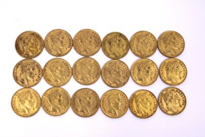a close up of a pile of gold coins on a white surface
