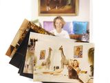 a picture of a woman sitting on a bed with a giraffe