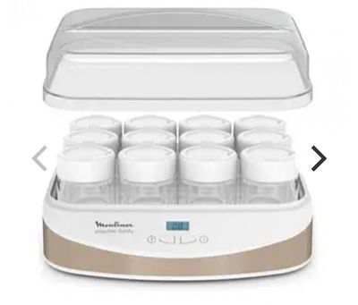 a close up of a bottle warmer with six bottles in it