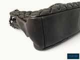 black leather handbag with braided handle and chain strap