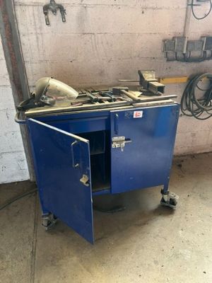a blue cabinet with a stove in it in a garage