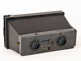 an old camera that is sitting on a white surface