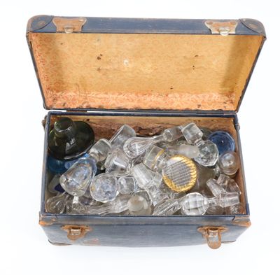 an open suitcase filled with glass items on a white surface