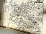 an old map of a city on a table