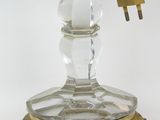 a glass candle holder with a clock on top of it