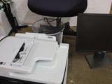 a printer sitting on top of a desk next to a computer monitor