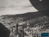 a black and white photo of an airplane flying over a field