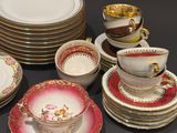 a lot of plates and cups that are sitting on a table