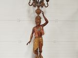 an image of a statue of a woman holding a candelabra