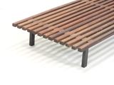 a wooden bench with metal legs on a white surface