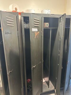 several metal lockers are lined up in a row in a room