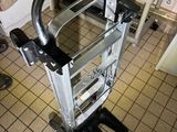 a hand truck that is sitting on a tiled floor