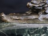 a statue of a bear that is on a marble base