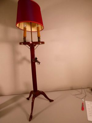 a lamp that has a red shade on top of it