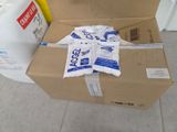 a cardboard box that is sitting on the floor next to a container