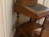 a small wooden table with a chalk board on top of it