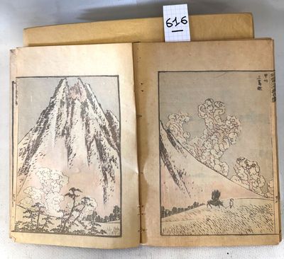 an old book with a picture of a mountain in the middle of it