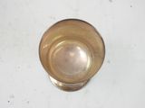 a glass of water sitting on a white surface