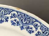 a close up of a plate with blue and white designs on it