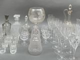 many glasses and vases that are sitting on a table
