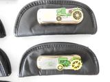 four pieces of leather with a green tractor on them on a white surface