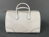 a white handbag on a gray background