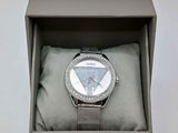 a watch in a box on a white surface