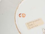 a close up of a plate with a sticker on it