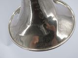 a silver bell that is sitting on top of a silver plate