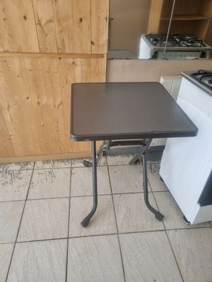 a small table that is on the floor in the kitchen