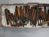 a box full of wooden tools sitting on a tile floor