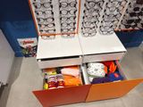 many pairs of glasses in the open drawer of a cabinet