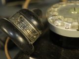 a close up of an old fashioned telephone on a table