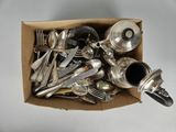 a box full of silverware on a white table