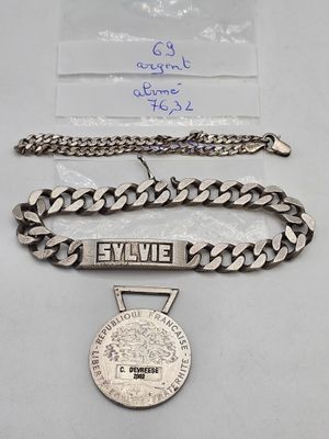 un gros plan d'une chaîne à laquelle est accrochée une médaille