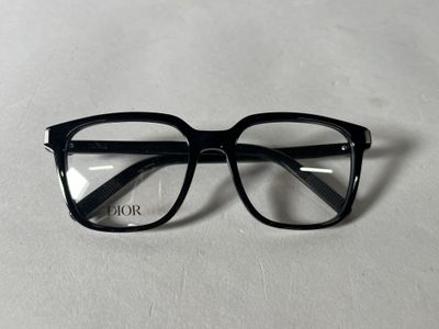 a pair of glasses sitting on top of a white surface
