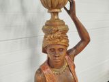 a statue of a woman carrying a pot on her head