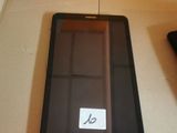 a tablet computer sitting on top of a box next to a remote