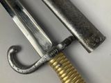 a close up of a knife with a handle on a table