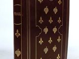 a brown book with gold decorations on the cover