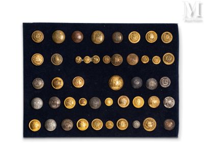 an assortment of gold and silver buttons on a black surface