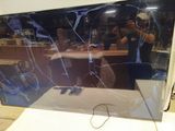 a man taking a picture of a broken tv screen