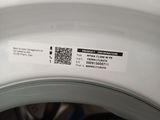 a close up of a white washing machine with a label on it